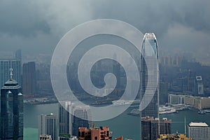 High modern buildings in fog and thick rain clouds of Hong Kong harbor from view point