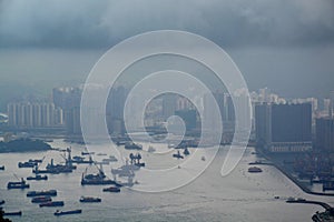 High modern buildings in fog and thick rain clouds of Hong Kong harbor from view point