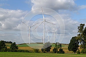 High modern windmill towers or electric power plants turbines in the background