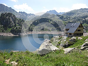 High mountain refuge next to a lake of glacial origin