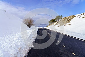 high mountain road with clouds and blue sky. Morcuera Madrid. Spain photo