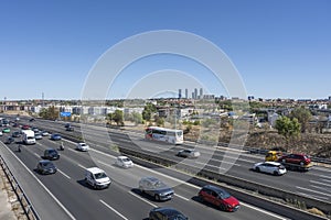 High mountain road with a convoy of 4x4s and off-road vehicles cautiously advancing