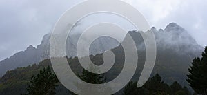 High mountain surrounded by myst. This mountain is located in Pyrenees photo