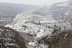 High-mountain, suspended rope bridge, which offers stunning views of the gorge, which runs a mountain river and a view of the vill