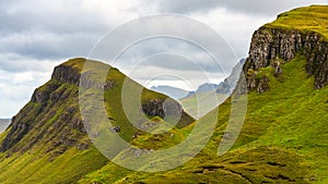 High mountain tops covered with green meadows in the north of the Isle of Skye, Scotland.