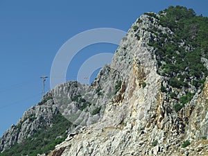 High mountains and cable car over blue sky background