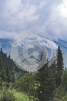 High mountains covered with clouds near Almaty city, Kazakhstan