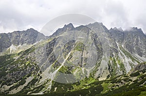 High mountains in the low clouds. Nature of High Tatras mountains. Slovakia, Europe.