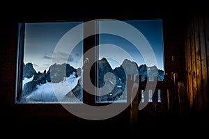 High mountains peaks range dusk evening through window view