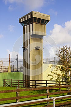 A high observation tower at the corner of a modern prison at Magilligan point in County Londonderry in Northern Ireland