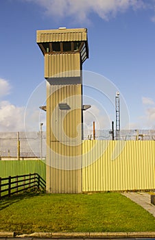 A high observation tower at the corner of a modern prison at Magilligan point in County Londonderry in Northern Ireland