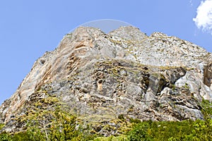 High peak with its stratum in mountains photo