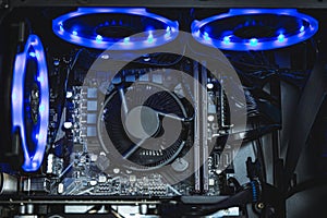 Computer circuit board and CPU cooling fans illuminated by internal LED