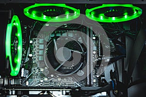 Computer circuit board and CPU cooling fans illuminated by internal LED