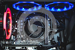 Computer circuit board and CPU cooling fans illuminated by internal LED