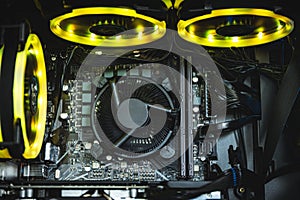 Computer circuit board and CPU cooling fans illuminated by internal LED