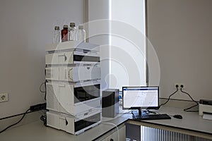 High performance liquid chromatography HPLC sample vial application for analysis some chemicals. The researcher placing the vial