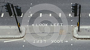 High perspective view of empty pedestrian crossing in the City of London. Iconic look left and look right signs painted