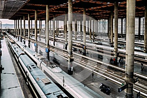 High perspective view of passengers and trains at Atocha, the the main railway station in Madrid, Spain