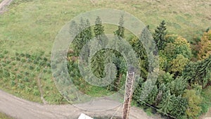 High pipe of waste burning plant in mountains. Smokestack. High smoke stack in mountain forest