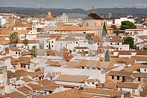 High point view on cityscape of Cordoba with church, white houses and tile roofs, Andalusia, Spain