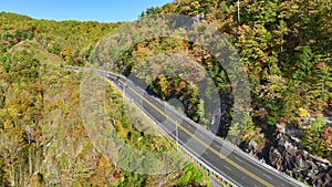 High point of view of highway route in North Carolina through Appalachian mountains in golden fall season with fast