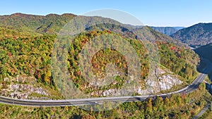 High point of view of highway route in North Carolina through Appalachian mountains in golden fall season with fast