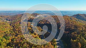 High point of view of highway route in North Carolina through Appalachian mountains in golden fall season with fast