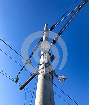High pole with a lamp and electric wires