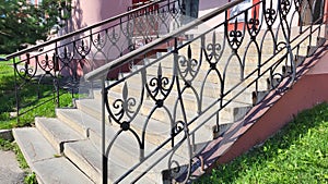 High porch with decorative wrought iron railings