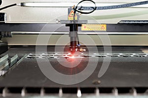 High precision CNC laser cutting metal sheet in factory.