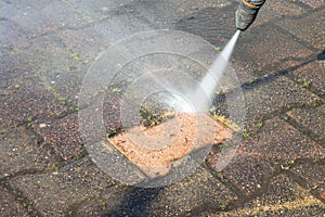 High pressure deep worker cleaning driveway with washer professional services