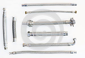 High pressure metal hoses of various formats and types on a white background, not insulated no isolated