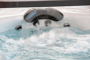 high pressure nozzles of a jacuzzi bath tubs at spa with headrest