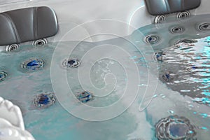 high pressure nozzles of a jacuzzi bath tubs at spa with headrest