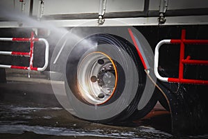High Pressured Water Washing Truck Wheels. Cleaning Truck Tires