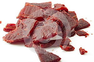 High protein diet and food that is high in sodium and salt concept theme with close up on beef jerky meat strips isolated on white