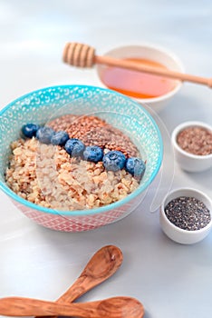 High protein healthy breakfast, buckwheat porridge with blueberries and honey