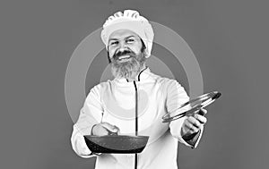 High quality frying pan. Bearded man cook white uniform. Homemade breakfast. Cooking like pro. Easy tasty meal prepared