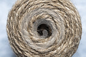 High-quality handmade coil made of natural hemp rope, isolated on a white background