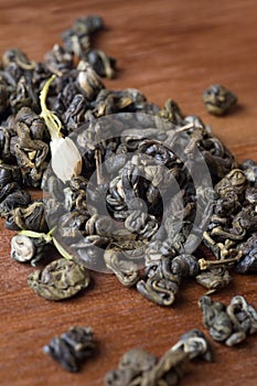 High quality jasmine green tea at wooden desk. macro shot