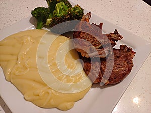 High quality top and lamp chops cooked insert with mashed potatoes and steamed Italian broccoli