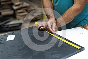 High quality wood concept. Cropped close up photo of cabinetmaker handcraft tradesman work with black mdf medium density