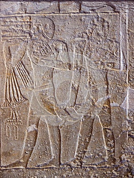 High Res ancient limestone Egyptian relief of human figures doing trades at the market