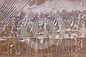 High Res ancient red limestone Egyptian relief of with detailed human figures on a vessel, texture background