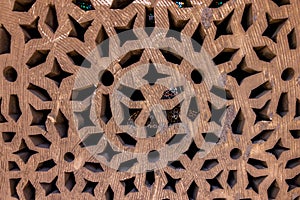 High res intricate arabesque relief decorated pale rough wood wall detail in Cairo, Egypt