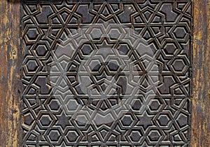 High res intricate dark geometric arabesque intense inlaid wood decorated door in Cairo photo