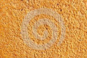 High res old vibrant rich yellow and orange tone rough stone wall, texture background close up