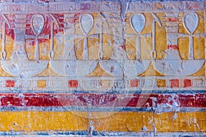 High Res well preserved ancient red limestone Egyptian vividly painted wall relief with detailed objects and Ankh symbols