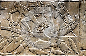 High Res well preserved painted ancient limestone Egyptian relief of human figures fishing from a vessel and hieroglyphs